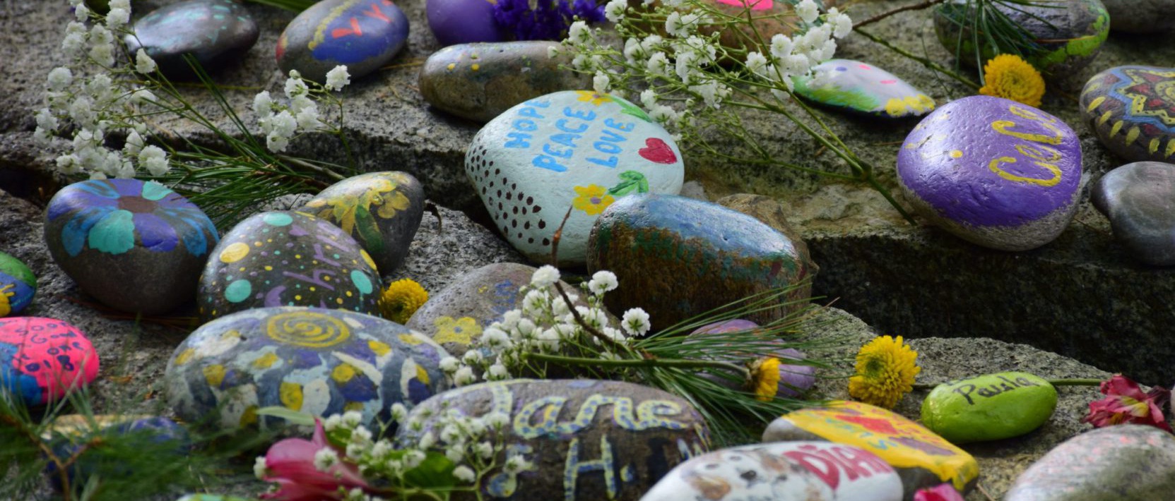 Colorfully painted rocks with flowers