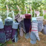 Handmade mittens hung on a clothes line